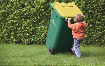 child pushing recycling cart